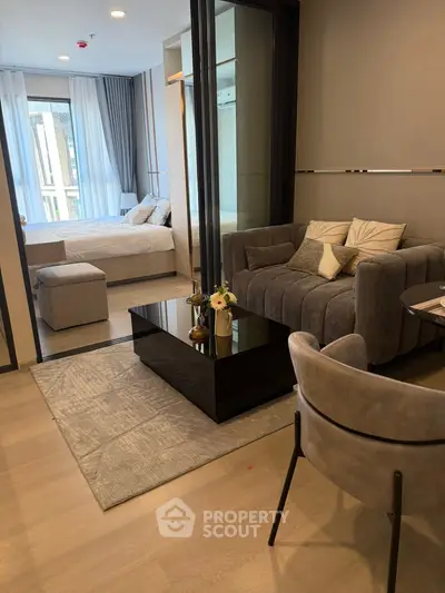 Modern living room with cozy seating and elegant decor in a stylish apartment.