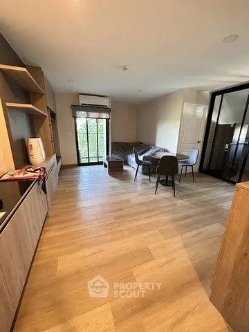 Spacious living room with modern furnishings and large windows for natural light.