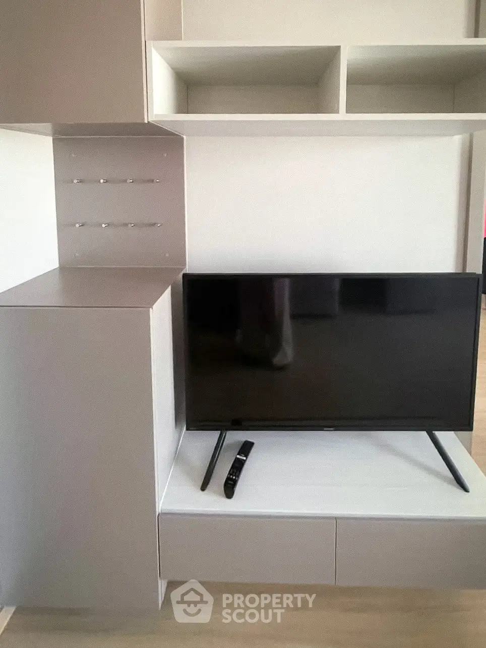 Modern living room with sleek TV unit and storage shelves, perfect for contemporary urban living.