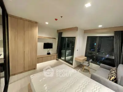 Modern bedroom with city view, featuring sleek furniture and ambient lighting for a cozy atmosphere.