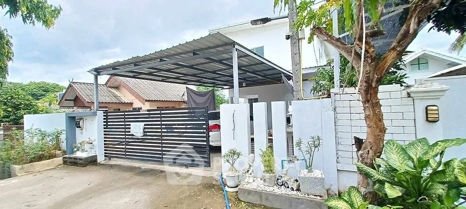 Charming suburban home with covered carport and lush greenery, perfect for family living.