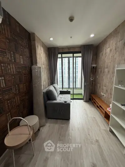 Cozy living room with modern decor and large window view in urban apartment