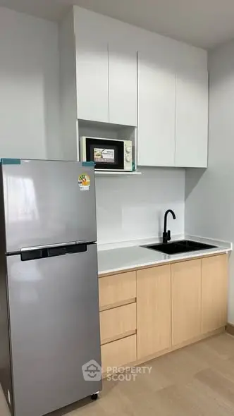 Modern kitchen with sleek cabinets and stainless steel fridge