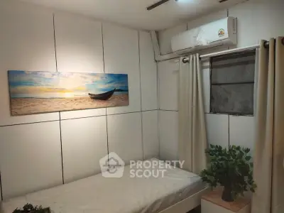 Cozy bedroom with air conditioning and beach-themed decor