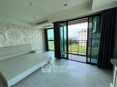 Spacious modern living room with large windows and balcony view