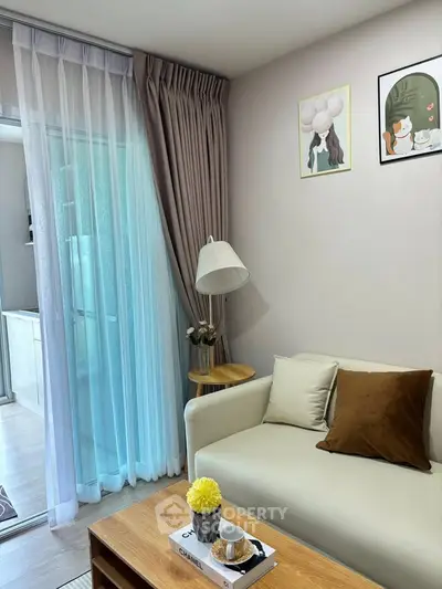 Cozy living room with modern decor and natural light, featuring a comfortable sofa and stylish coffee table.