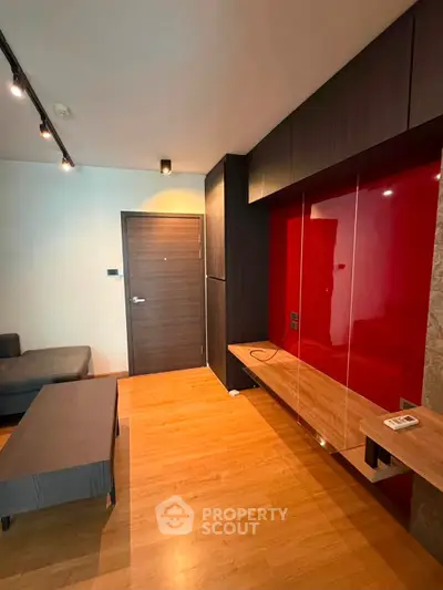 Modern living room with sleek design and vibrant red accent wall