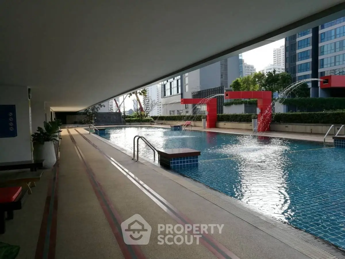 Luxurious outdoor pool area with modern design in a high-rise residential complex.