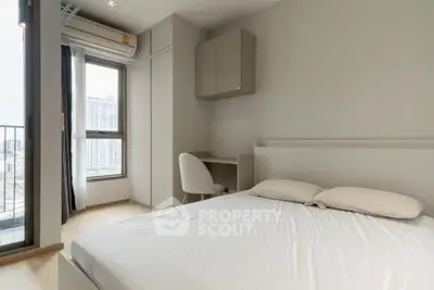 Modern bedroom with city view and minimalist decor