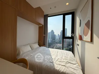 Modern bedroom with city view, featuring stylish decor and large window for natural light.