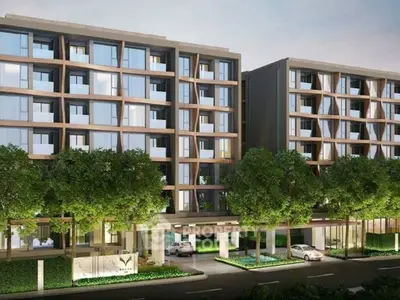 Modern apartment building with lush greenery and sleek architectural design.