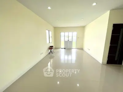 Spacious and bright living room with large windows and minimalist design.