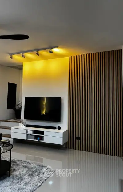 Modern living room with sleek TV setup and ambient lighting