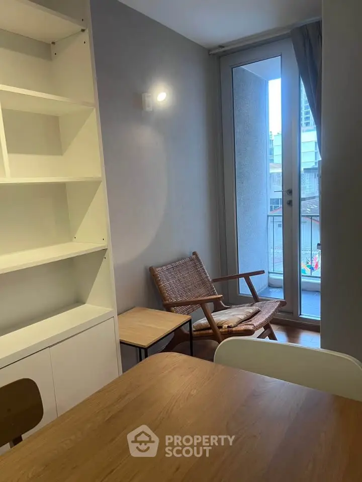 Cozy interior with modern furniture and small balcony access, perfect for urban living.