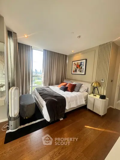 Luxurious bedroom with modern decor and city view, featuring elegant hardwood floors and stylish furnishings.