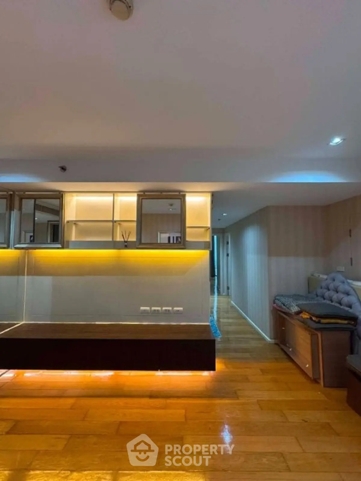 Spacious modern living room with wooden flooring and ambient lighting