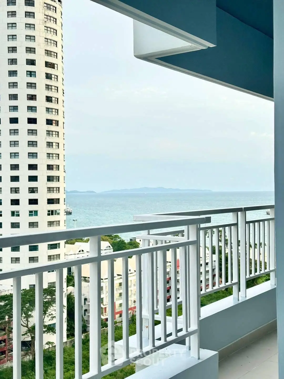 Stunning ocean view from a high-rise balcony with modern railing.
