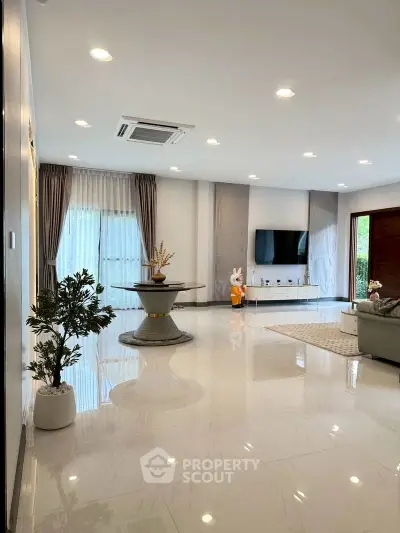 Spacious modern living room with elegant decor and large windows for natural light.