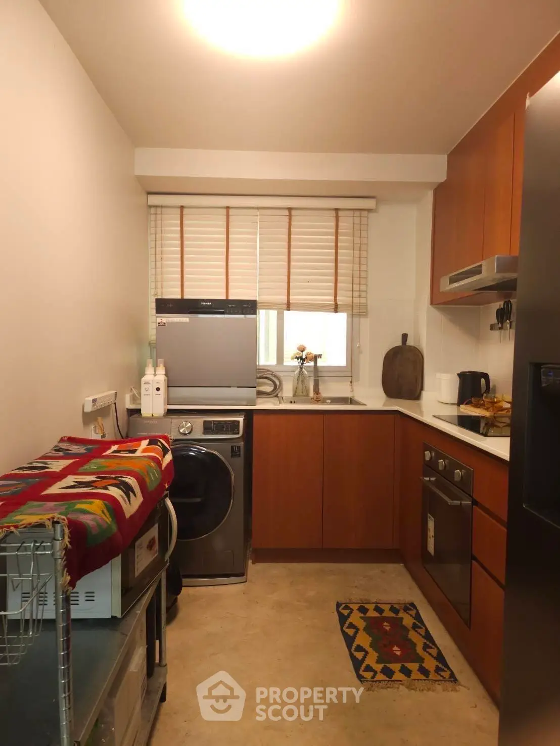 Cozy kitchen with modern appliances and warm wooden cabinetry
