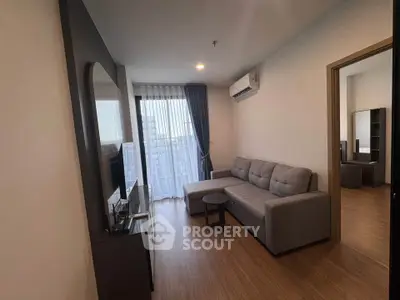 Modern living room with sleek furniture and natural light in a stylish apartment.