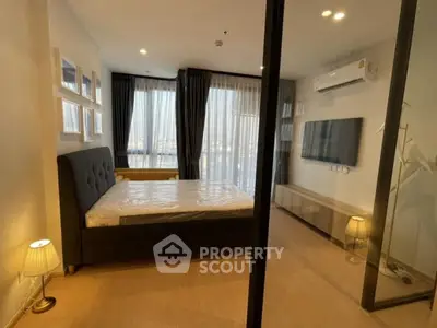 Modern bedroom with large windows and stylish decor in a high-rise apartment.
