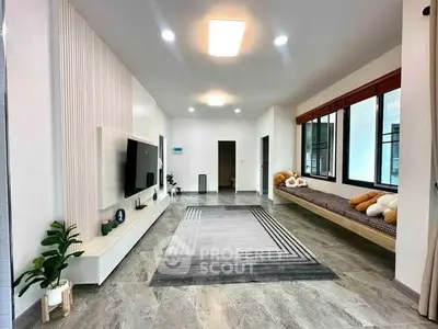 Spacious modern living room with stylish decor and large windows