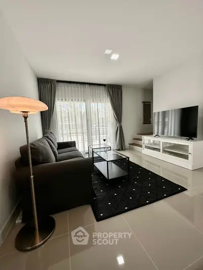 Modern living room with sleek furniture and large window view