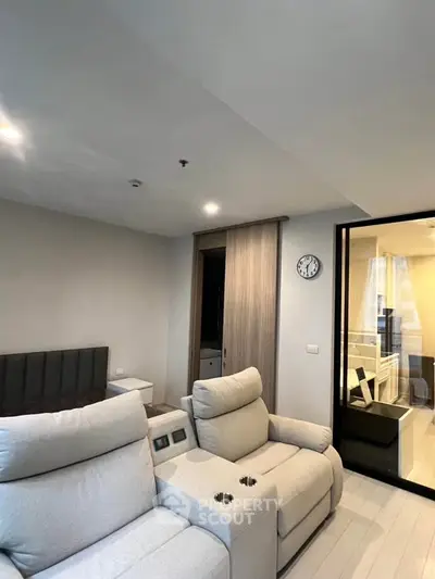 Modern living room with plush seating and stylish decor in a contemporary apartment.