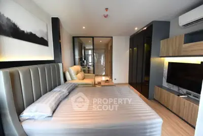 Luxurious modern bedroom with sleek design and ambient lighting, featuring a comfortable bed and stylish decor.