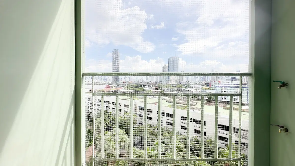 Stunning cityscape view from a high-rise balcony with modern railing and urban skyline.
