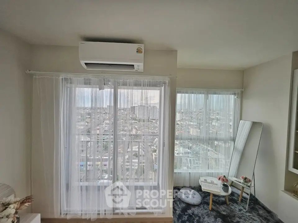 Modern high-rise apartment with panoramic city view and stylish interior design.