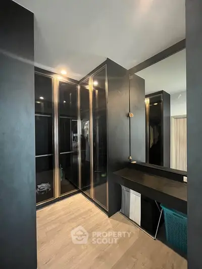 Luxurious walk-in closet with sleek black cabinetry and ample storage space