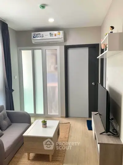 Modern living room with sleek furniture and air conditioning in a cozy apartment.
