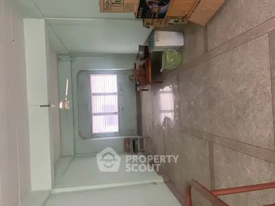 Spacious room with large window and minimal furnishings, ideal for customization.