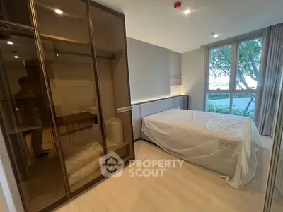Modern bedroom with large window and sleek wardrobe design