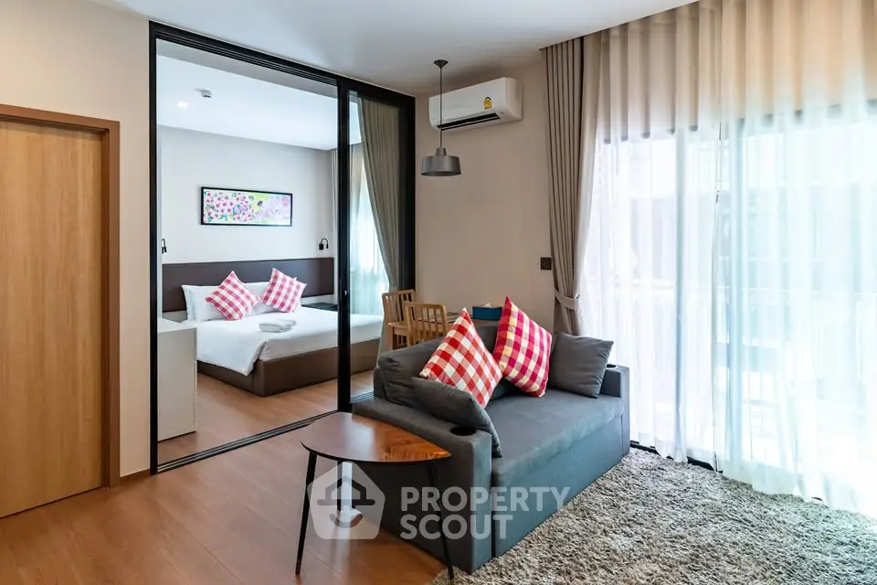 Modern living room with cozy sofa and stylish decor in open layout apartment.