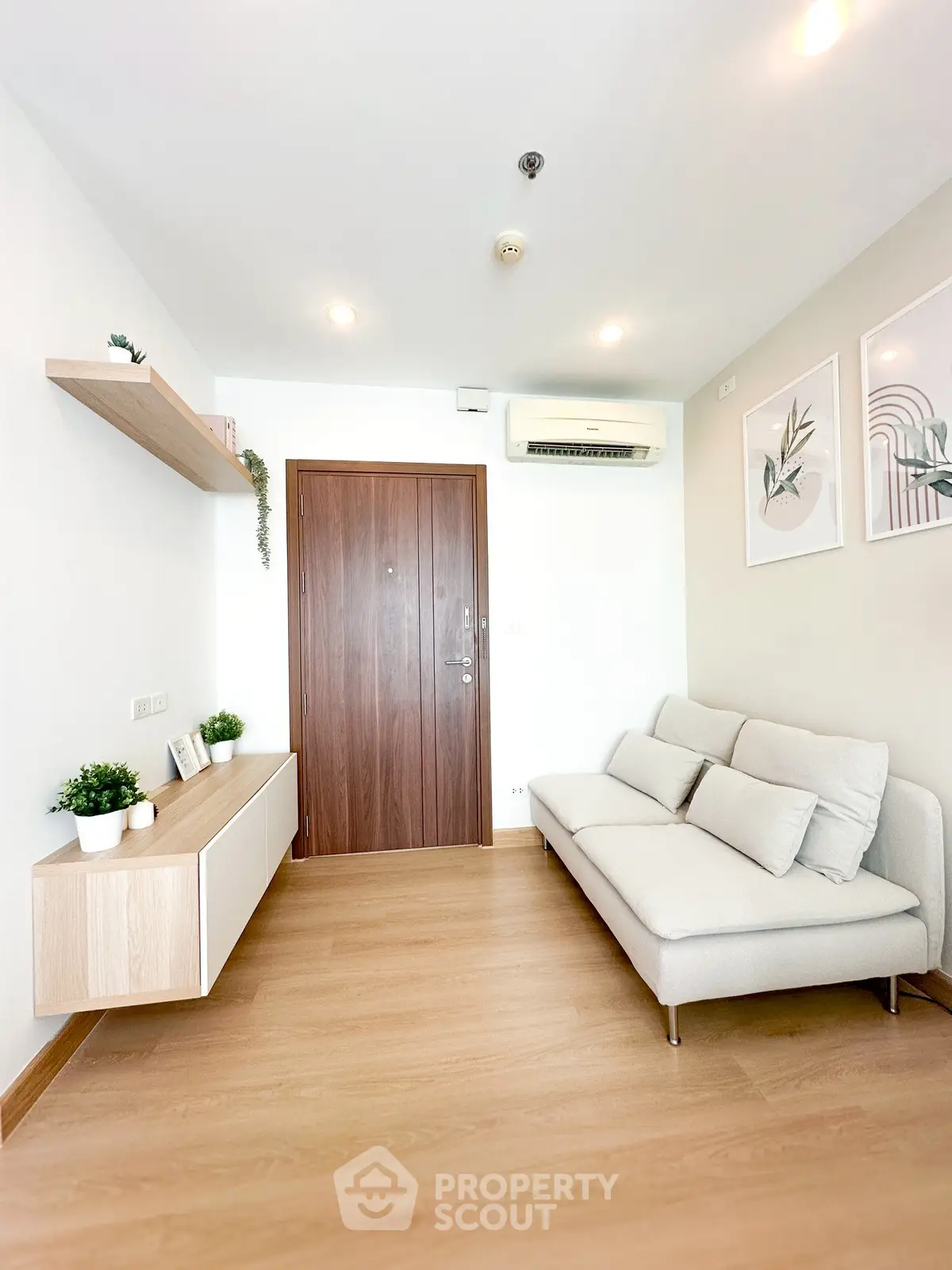 Modern minimalist living room with wooden flooring and sleek furniture