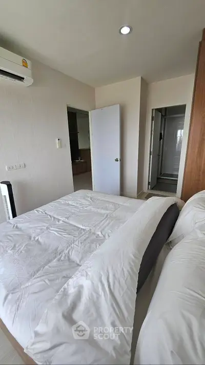 Cozy bedroom with modern design and ensuite bathroom in a stylish apartment.