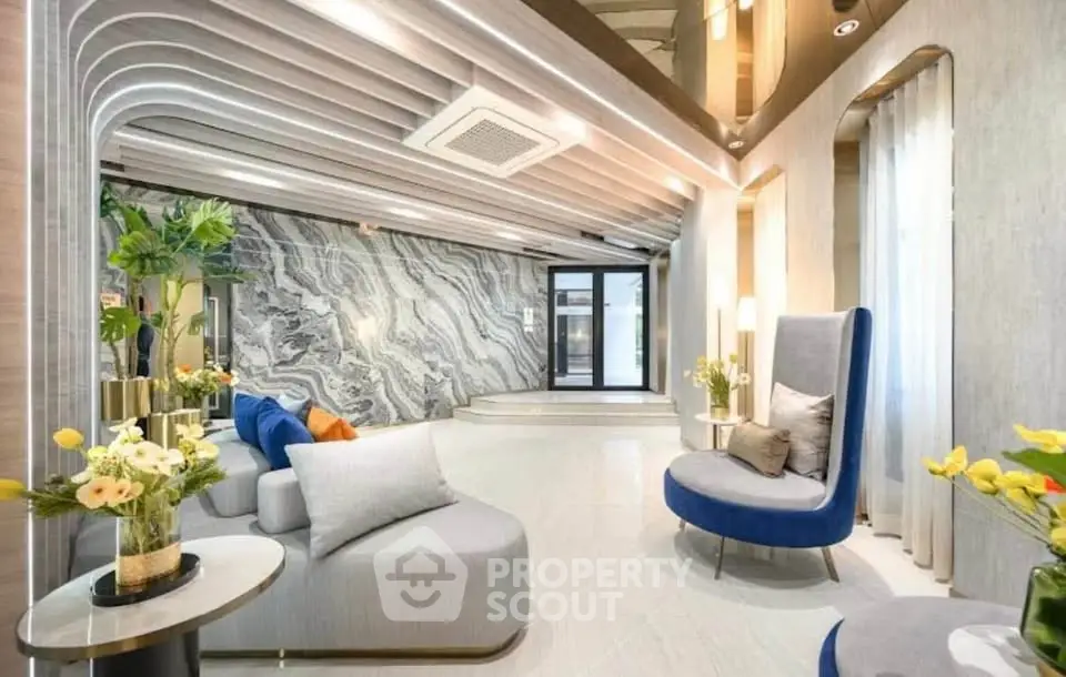 Luxurious modern living room with elegant decor and stylish furniture, featuring a unique ceiling design and marble accent wall.