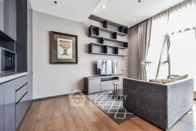 Modern living room with sleek furniture and large windows, featuring a stylish shelving unit and hardwood floors.