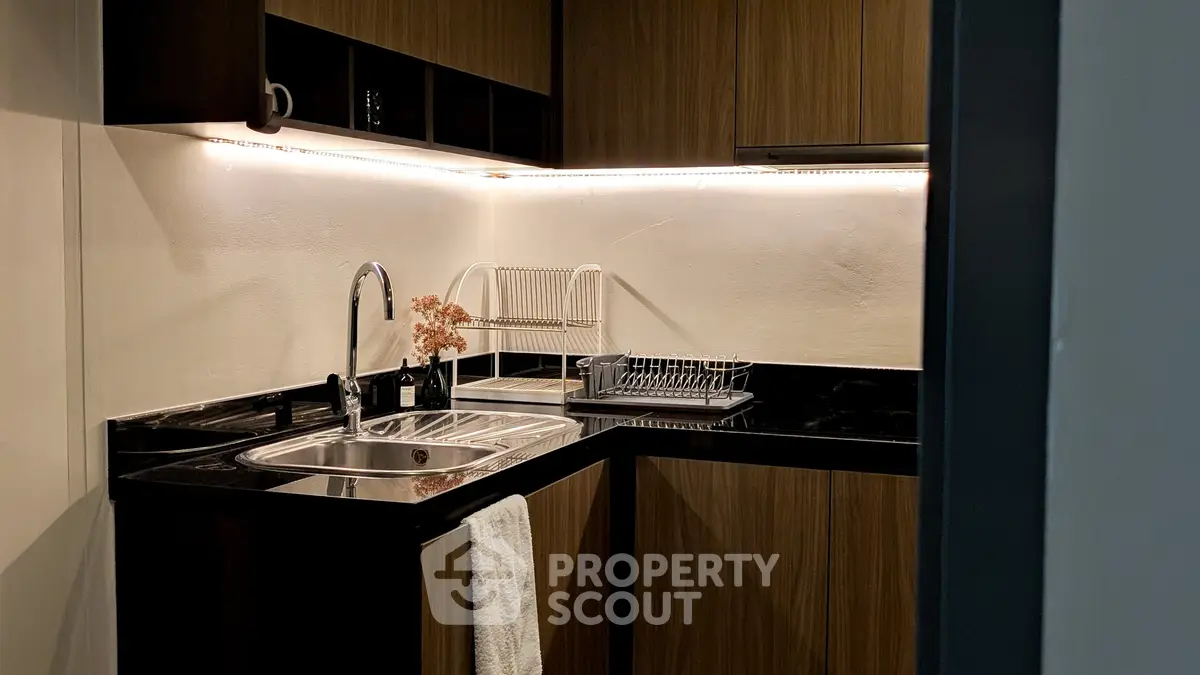 Modern kitchen with sleek black countertops and wooden cabinets