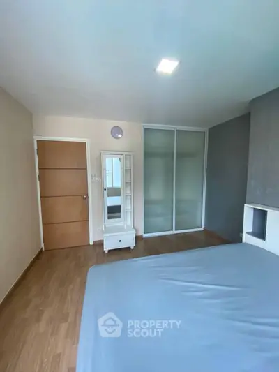 Spacious bedroom with modern design and ample natural light