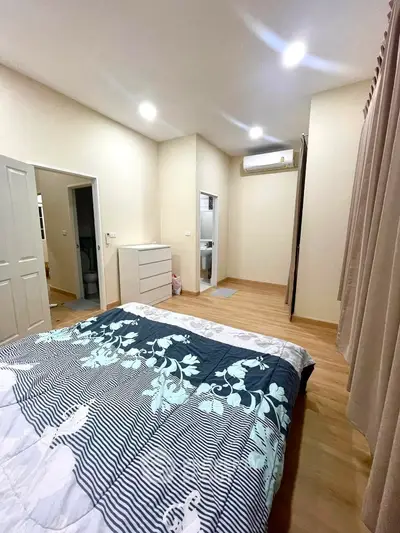 Spacious bedroom with modern decor and ample natural light