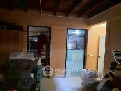 Cozy interior space with storage and view into a kitchen area, ideal for organizing and home improvement.