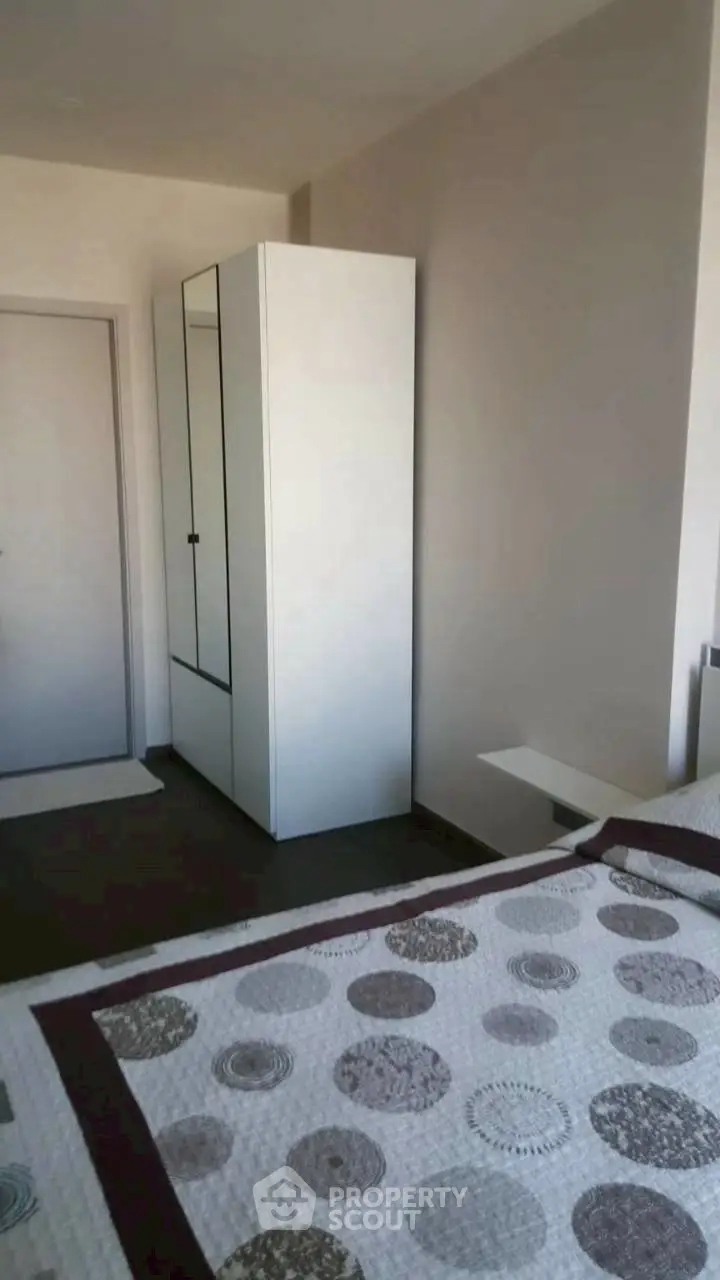 Cozy bedroom with modern wardrobe and stylish bedding