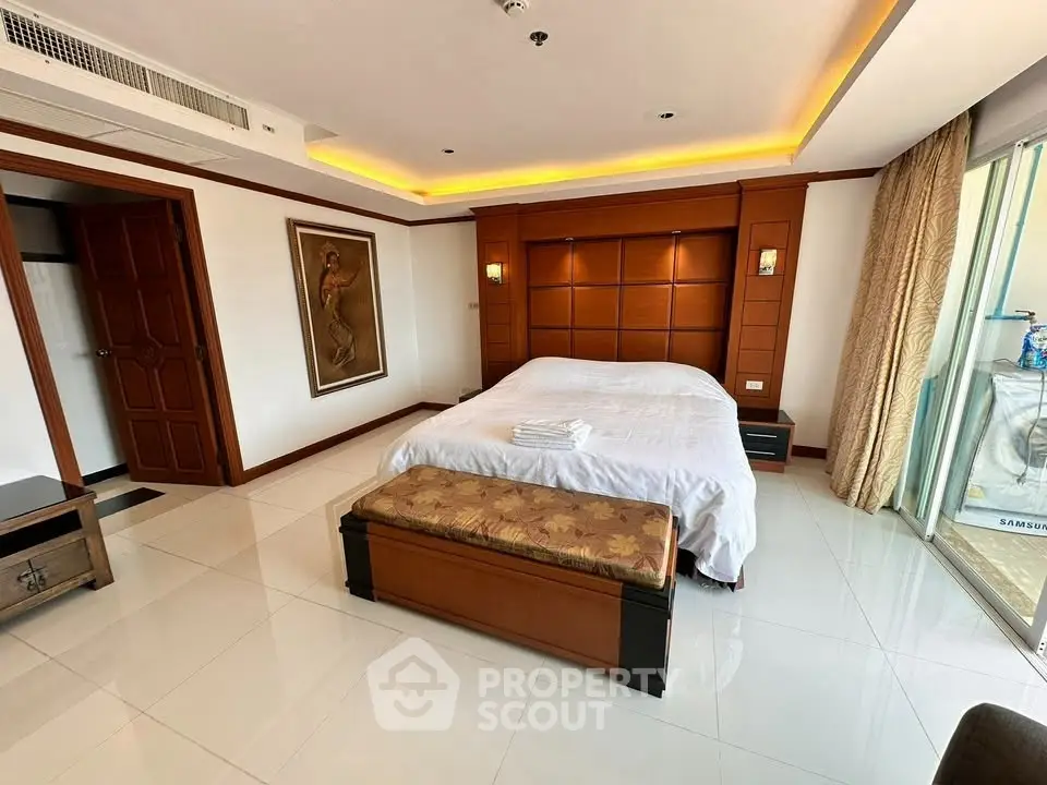 Luxurious bedroom with elegant decor and large windows for natural light.