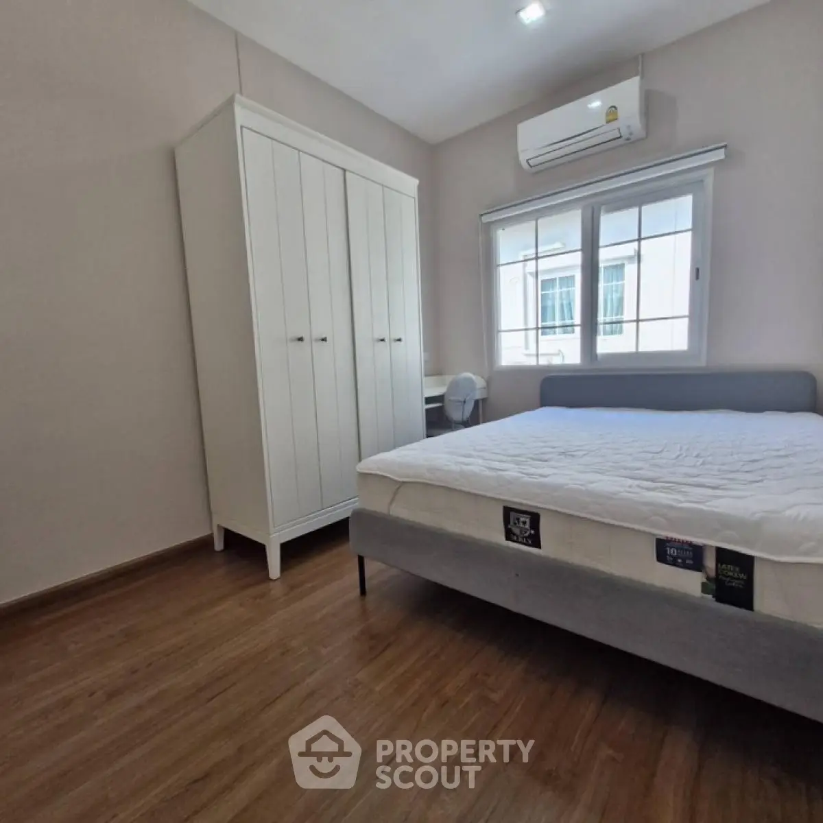 Spacious bedroom with modern furnishings and natural light