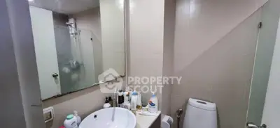 Compact bathroom with modern fixtures and ample storage space.