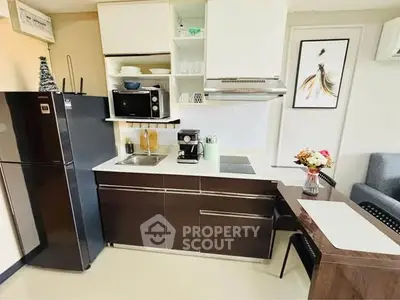 Modern kitchen with sleek cabinetry, stainless steel appliances, and cozy dining area.