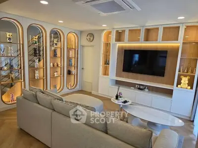 Luxurious living room with modern decor, built-in shelves, and ambient lighting.